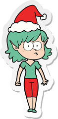 sticker cartoon of a elf girl staring wearing santa hat