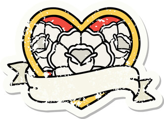 traditional distressed sticker tattoo of a heart and banner with flowers