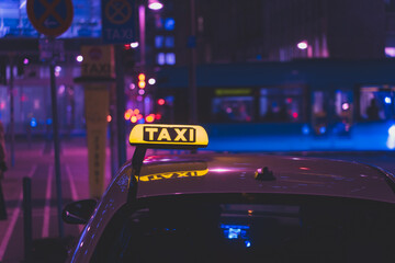 illuminated taxi sign in the city at night