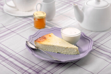 Cottage cheese casserole for breakfast. Serving in lilac tones.