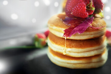 pancakes with honey. Original American pancakes with honey and raspberries close-up with a copy space
