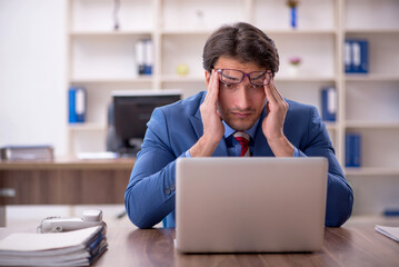 Young male employee working in the office