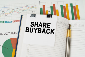 On the business charts is a notepad with the inscription - Share buyback