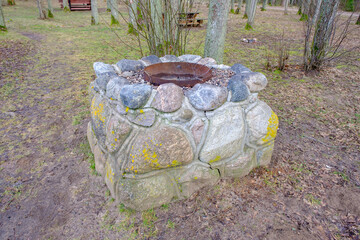 idyllic outdoor barbecue area - built with flat stones campfire place. For public use