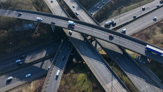 Vehicles Driving Along a Busy Motorway Interchange in the UK Aerial View