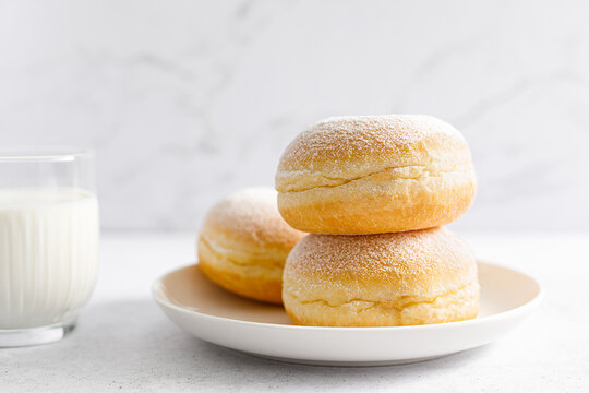 Berliner donut. Traditional german donut with raspberry jam, dusted with icing sugar