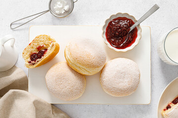 Berliner donut. Traditional german donut with raspberry jam, dusted with icing sugar. Top view