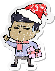 distressed sticker cartoon of a man sweating wearing santa hat