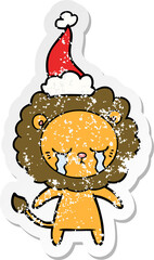 crying distressed sticker cartoon of a lion wearing santa hat