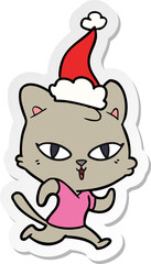 Fototapeta premium sticker cartoon of a cat out for a run wearing santa hat