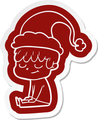 cartoon  sticker of a happy boy wearing santa hat