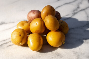 group of potatoes on a marble surface 