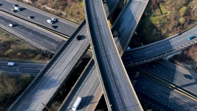 Vehicles Driving Along a Busy Motorway Interchange in the UK Aerial View