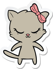 sticker of a cute cartoon cat with bow