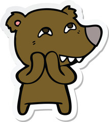 sticker of a cartoon bear showing teeth