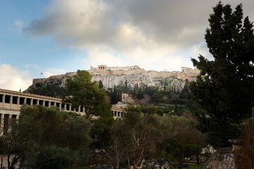 Fototapeta na wymiar Ruins of Ancient Agora with Acropolis in background during sunset in winter, Athens, Greek, Europe