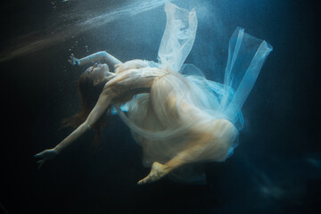 Young beautifull caucasian woman in dress under water - obrazy, fototapety, plakaty