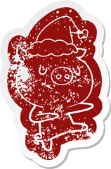 happy cartoon distressed sticker of a pig dancing wearing santa hat