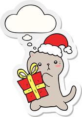 cute cartoon cat carrying christmas present and thought bubble as a printed sticker