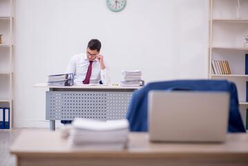 Young male employee working in the office