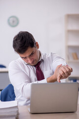 Young male employee working in the office