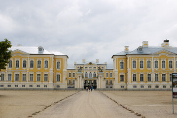Fototapeta na wymiar Latvian Rundale Palace and palace garden in summer, an alley of green trees and a garden
