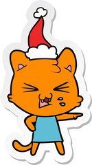 sticker cartoon of a hissing cat wearing santa hat