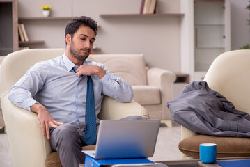 Young male employee working from home