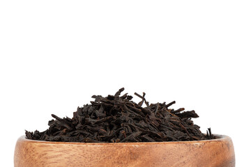 Close-up of black loose leaf tea on a white background with space for text.