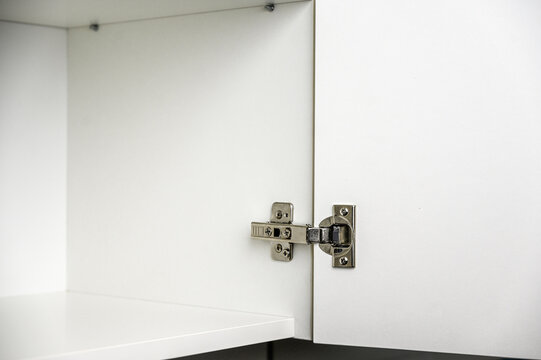 Stainless furniture hinge for cabinet or closet doors. Furniture assembly