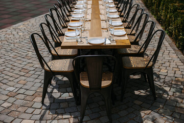 A large table was set on the street near a house outside the city.