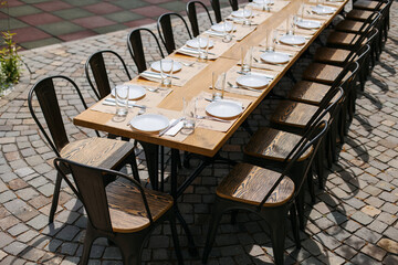 A large table was set on the street near a house outside the city.