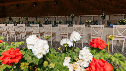 A table set in a wooden arch near a house outside the city. Birthday decor.