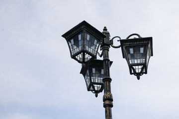 Fototapeta na wymiar Metal street lamp on the background of the sky