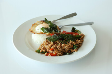 Pad Kra Pow with chicken in bowl with rice and fried thai basil - obrazy, fototapety, plakaty