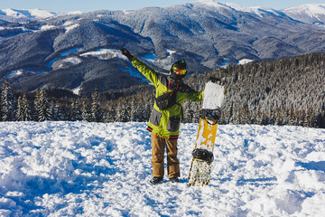 Winter sport. A snowboarder walks down a snowy slope in winter on the snow. Snowboarding, winter...