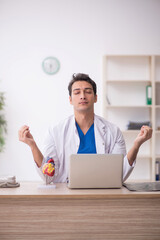 Young male doctor working in the clinic