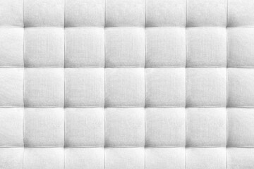 White suede leather background for the wall in the room. Interior design, headboards made of furniture fabric, furniture upholstery. Classic checkered pattern for furniture, wall, headboard