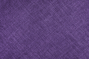 Jacquard woven upholstery, purple coarse fabric texture with diagonal weave lines. Textile background, furniture textile material, wallpaper, backdrop. Cloth structure close up.