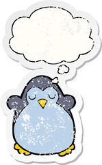 cartoon penguin and thought bubble as a distressed worn sticker