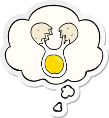 cartoon cracked egg and thought bubble as a printed sticker