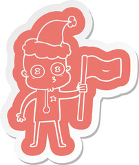 cartoon  sticker of a weird bald spaceman with flag wearing santa hat