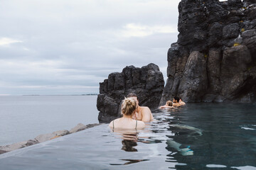 Sky Lagoon in Iceland. Geothermal spa with heated water on cold day © Renata