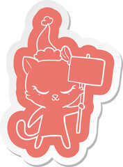 cute cartoon  sticker of a cat with sign wearing santa hat