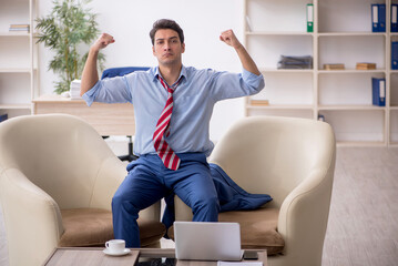 Young male employee sitting in the office