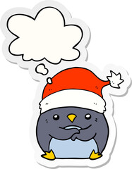 cute cartoon penguin wearing christmas hat and thought bubble as a printed sticker