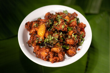 A serving of a vegetarian dish made from fried cauliflower. Known as 'gobi 65', it is based on the 'gobi chicken' recipe originating from southern India.