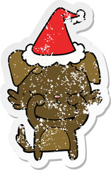 cute distressed sticker cartoon of a dog wearing santa hat