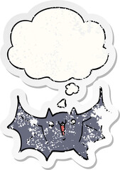 cartoon happy vampire bat and thought bubble as a distressed worn sticker