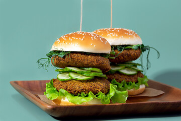 Vegetable burgers on green background